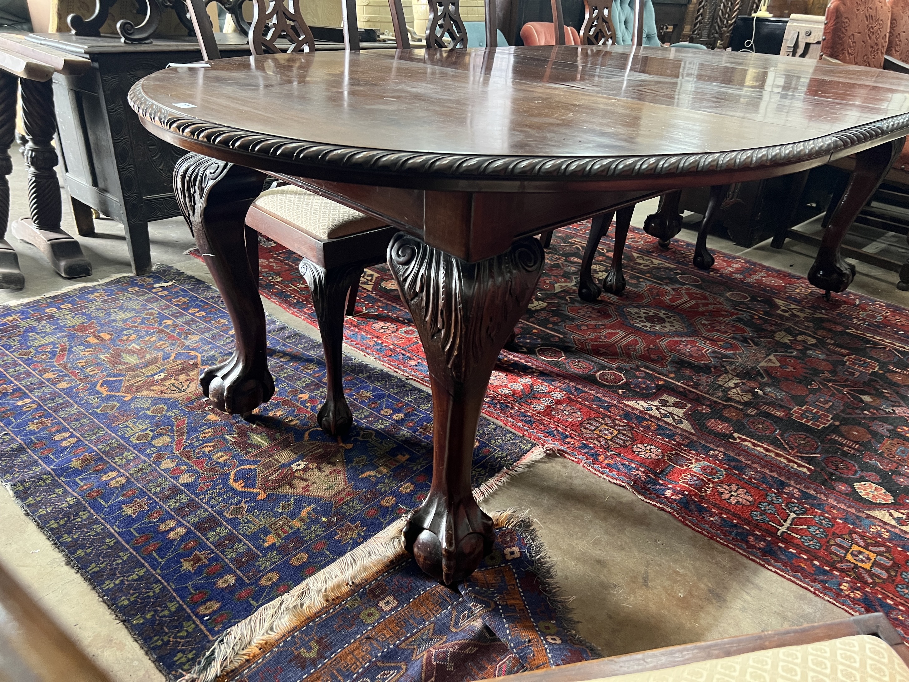 A 1920's Chippendale revival mahogany oval topped extending dining table, 238cm extended, two spare leaves, depth 120cm, height 76cm